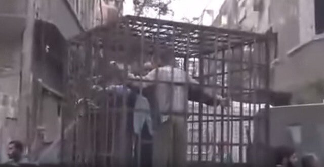 Video: Caged Alawites as Human Shields to Deter Barrel Bombs